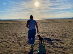 Woman walking on Weston-super-Mare beach - hypnotherapy for menopause and perimenopause